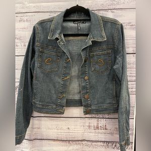 Blue Clash cropped denim jacket with brown stitching. Please note the tiny hole